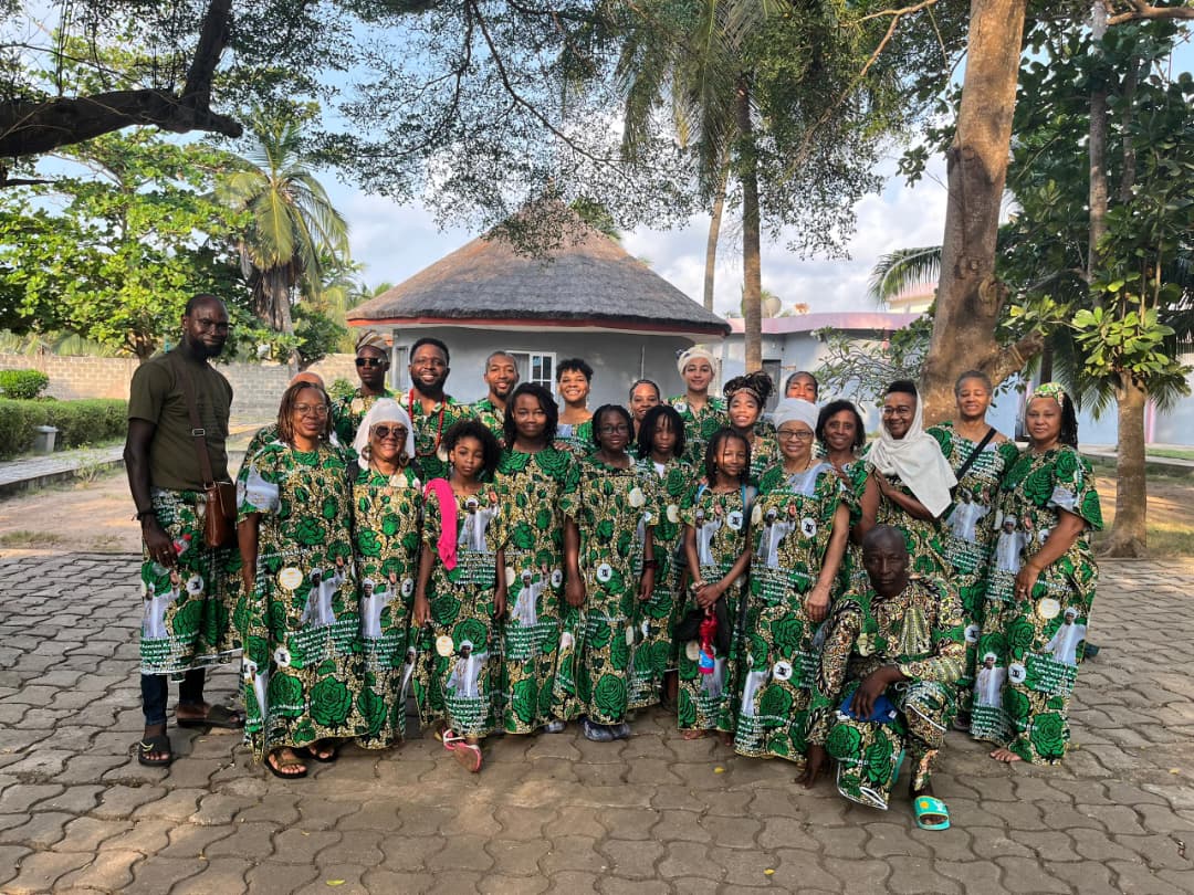 Pilgrim cohort gathered in matching green ceremonial dress in Tado